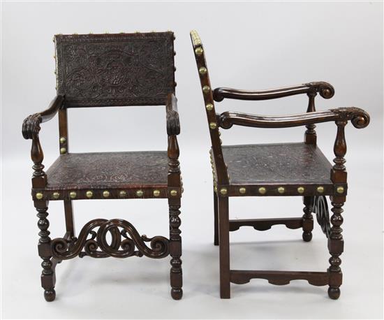 A pair of 17th century Spanish style stained and carved beech elbow chairs,